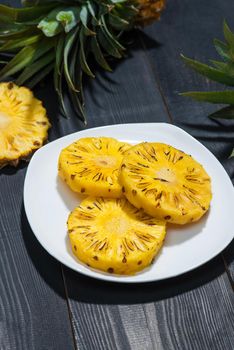Grilled pineapple on a black wooden table