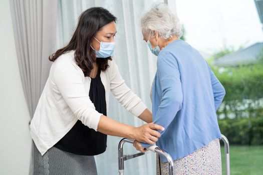 Help and care Asian senior or elderly old lady woman use walker with strong health while walking in hospital.