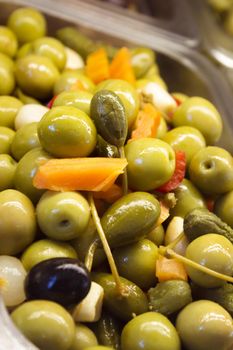 Pitted and pitted green olives with pepper and carrot. No copy space