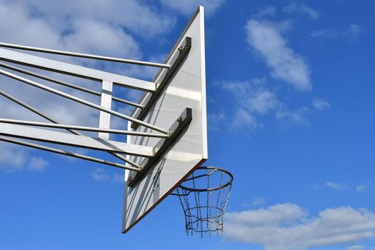 basketball, defenders hoop on a field with blue sky