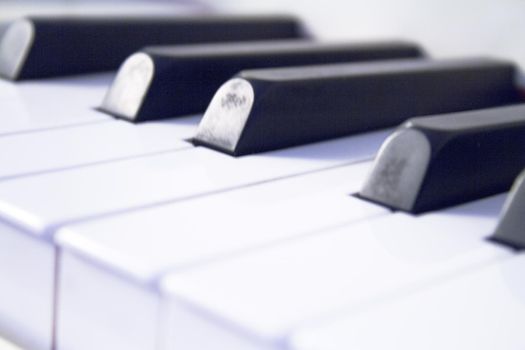 Part of the keyboard of a piano in white color. No people