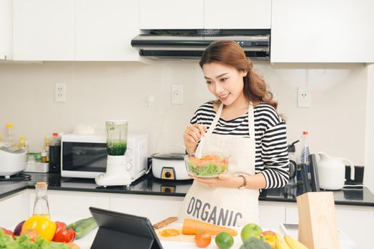 Young happy woman eating salad. Healthy lifestyle with green food.