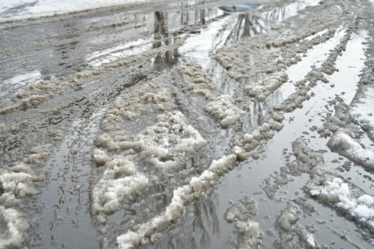 Slush on the road during winter snowfall.
