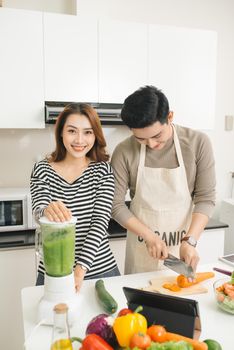 Asian couples lover cooking together in the kitchen at home