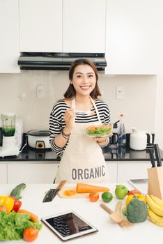 Young happy woman eating salad. Healthy lifestyle with green food.