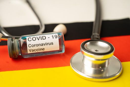 Stethoscope with Covid-19 Coronavirus vaccine on Germany flag.