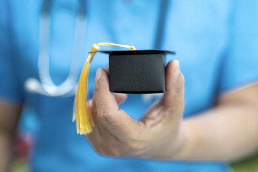 Asian doctor study learn with graduation gap hat in hospital ward : clever bright genius education medicine concept.