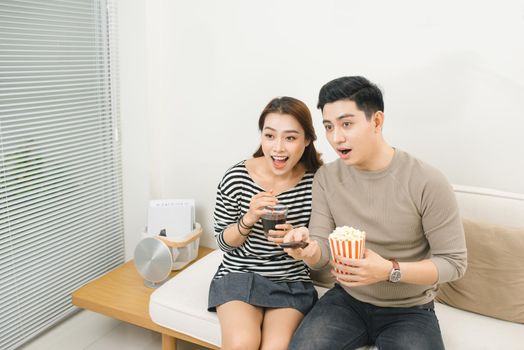 Relaxed young couple watching television in their living room