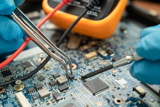 technician repairing inside of hard disk by soldering iron. Integrated Circuit. the concept of data, hardware, technician and technology.