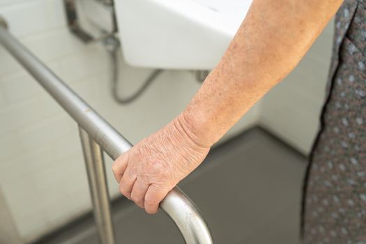 Asian senior or elderly old lady woman patient use toilet bathroom handle security in nursing hospital ward : healthy strong medical concept.