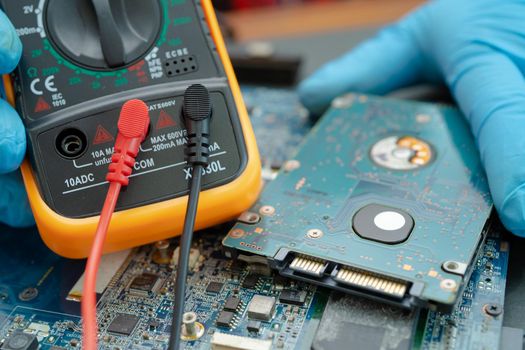 technician repairing inside of hard disk by soldering iron. Integrated Circuit. the concept of data, hardware, technician and technology.