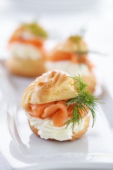 Profiteroles stuffed with cream cheese and salmon.