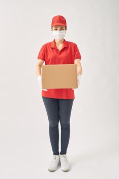Delivery women in medical mask and rubber gloves holding cardboard boxes.