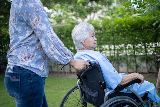 Doctor help and care Asian senior or elderly old lady woman patient sitting on wheelchair at park in nursing hospital ward, healthy strong medical concept.