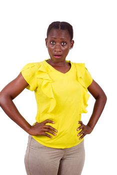 young girl standing in yellow camisole hands on hip looking at camera surprise.
