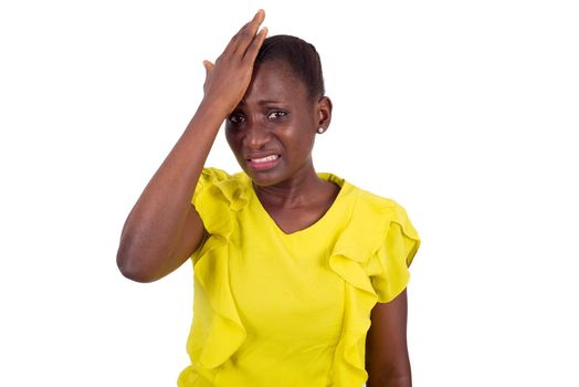 Frustrated woman holding hand on her forehead being depressed or having forgotten, look at the camera with her face wrinkled