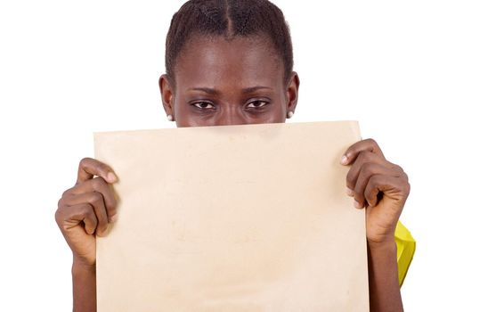 young girl standing in yellow camisole with khaki envelope closing mid face and looking at the camera.