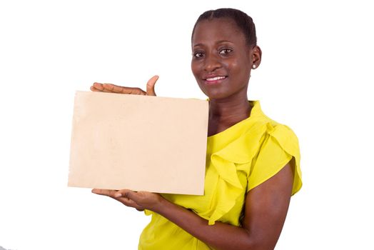 Smiling woman showing a blank sheet of paper with copy space for advertising on white studio background