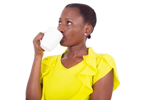 Enjoying fresh coffee. Beautiful young woman drinking coffee and having her eyes raised in studio