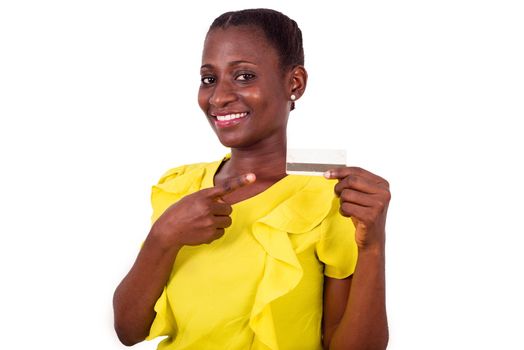 Happy woman standing on white background showing a credit card