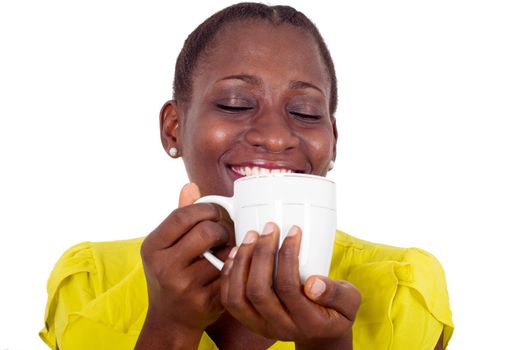 young happy woman drinking an aromatic coffee in her hands in studio
