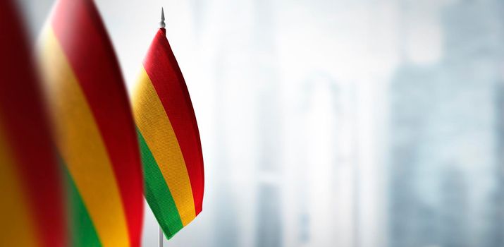 Small flags of Bolivia on a blurry background of the city.