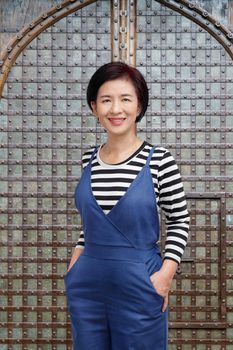 middle aged asian woman smiling in casual clothes