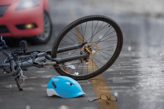 Accident car crash with bicycle on road ,rainy day.