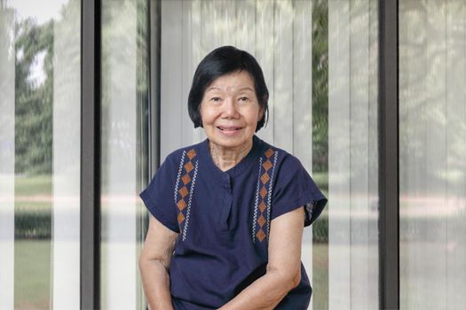 Happy asian woman relaxing at home in the living room