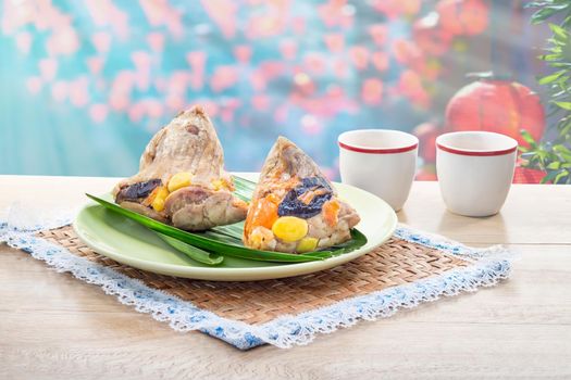 Rice dumplings or zongzi is a traditional Chinese food, made of glutinous rice stuffed with different fillings and wrapped in bamboo or reed leaves. They are cooked by steaming or boiling.