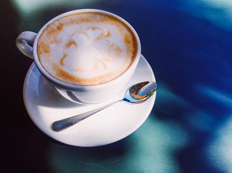 Cappuccino in summer cafe outdoors.