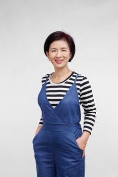 middle aged asian woman smiling in casual clothes