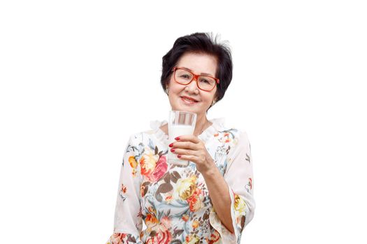 Senior woman holding a glass of milk , isolated on white background.