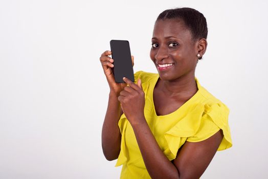 Young smiling and fun woman showing mobile phone display with black screen