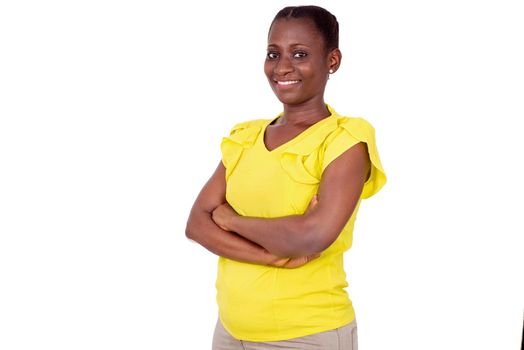 girl standing in camisole arms crossed looks at the camera smiling.