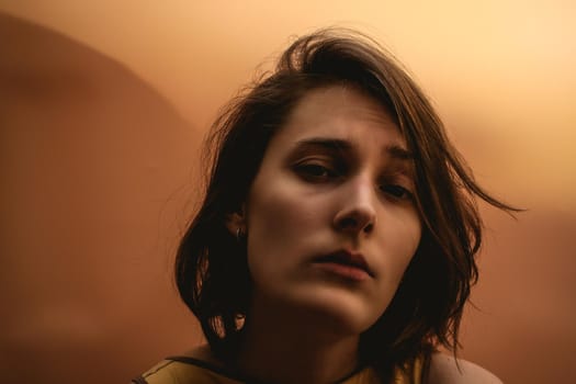 Dark portrait of a young woman with raised eyebrow
