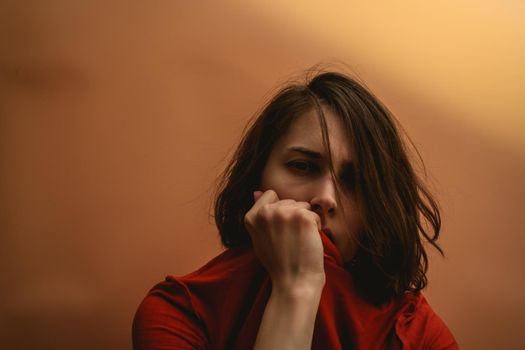 Young woman stretches a T-shirt. Hide your face