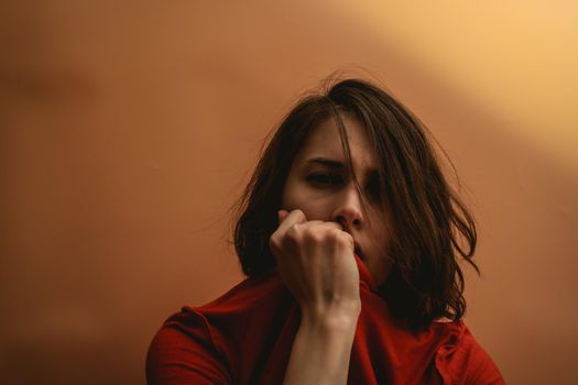 Young woman stretches a T-shirt. Hide your face