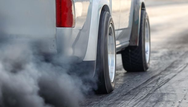 Air pollution from vehicle exhaust pipe on road