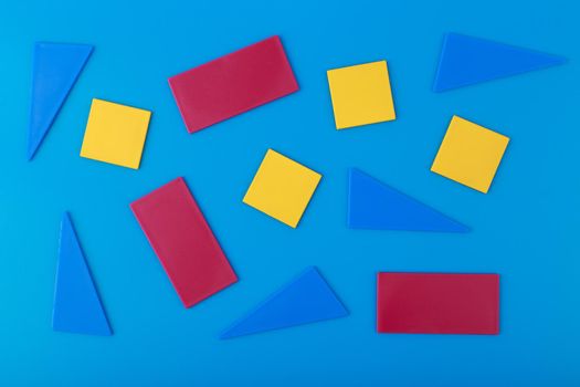 Abstract composition with multicolored geometric figures on blue background. Concept of template for covers, posters, banners or flyers