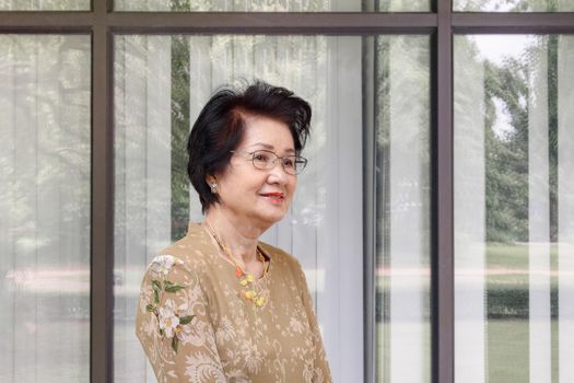 Happy asian woman relaxing at home in the living room