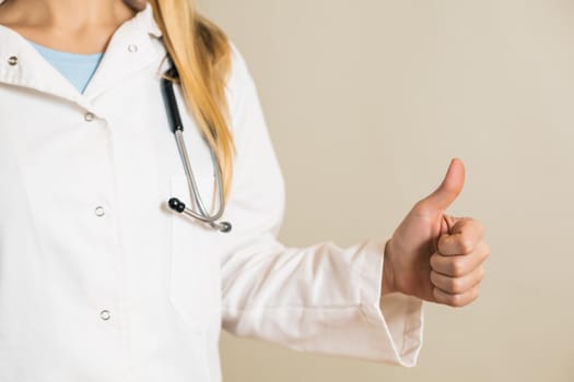 Image of female doctor showing thumb up.