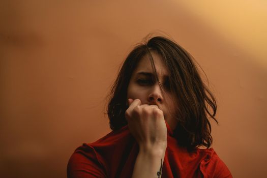 Young woman stretches a T-shirt. Hide your face