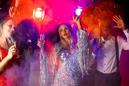 Group people with champagne dancing at party