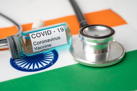 Stethoscope with Covid-19 Coronavirus vaccine on India flag.