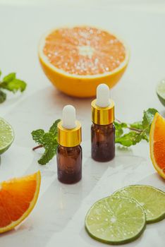 organic cosmetics with herbal extracts of lemon, orange, mint on bright background