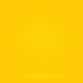 Abstract solid of shining yellow gradient studio wall room background