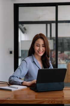 Portrait asian Businesswoman Working On Laptop In cafe coffee shop.