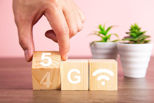 5G (5th Generation) network connecting technology future global. Hand flip wood cube change number 4G to 5G