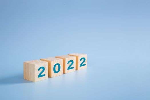 2022 number on wooden block on blue background - 2022 new year concept